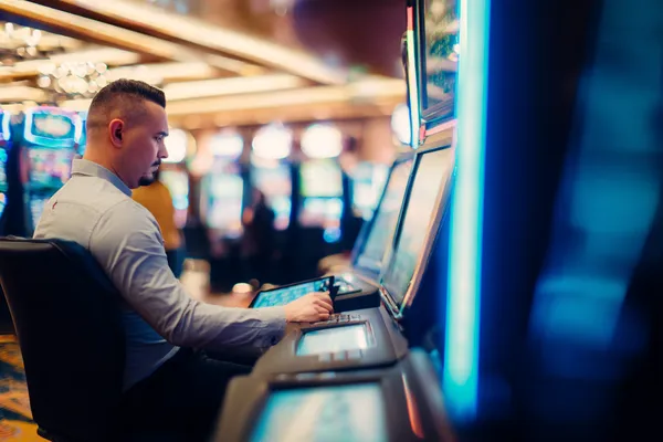 A young woman relaxing with her phone while dynamic casino elements float around her, illustrating the smooth mobile experience offered by the qwe123 app.